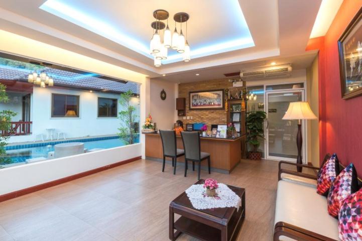 a living room with a couch and a table at Katanoi Resort in Kata Beach