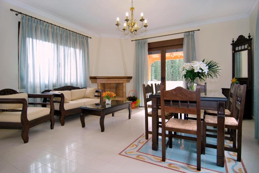 a living room with a couch and a table and chairs at Kerveli Luxury Villa in Kerveli