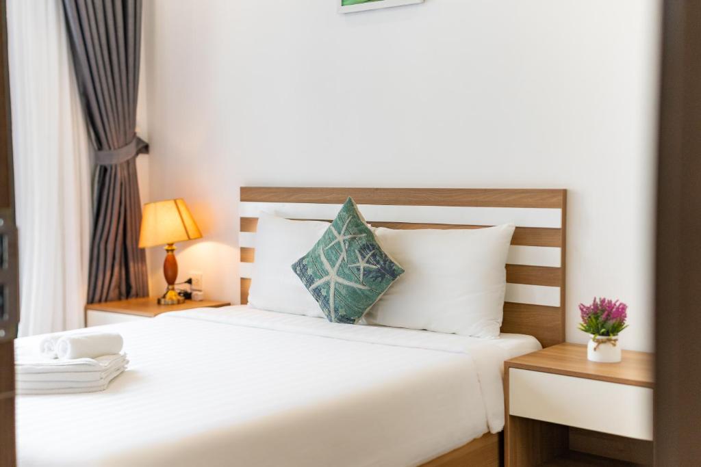 Postel nebo postele na pokoji v ubytování Phuc Lam Hotel Grand World Phu Quoc