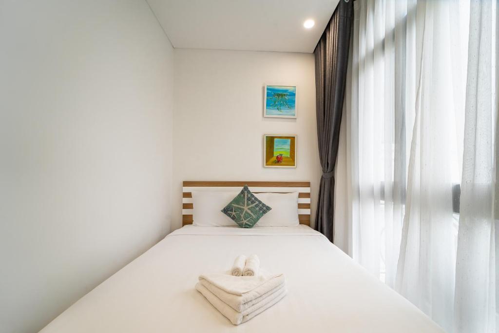 Postel nebo postele na pokoji v ubytování Phuc Lam Hotel Grand World Phu Quoc
