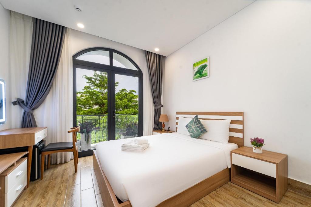 Postel nebo postele na pokoji v ubytování Phuc Lam Hotel Grand World Phu Quoc