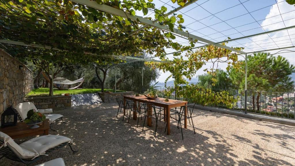 a table and chairs on a patio with a view at Luxury Apartments in Modern Villa in Imperia
