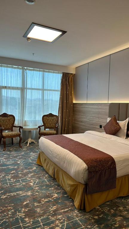 Postel nebo postele na pokoji v ubytování Sadeem Al Fajr Hotel Suites