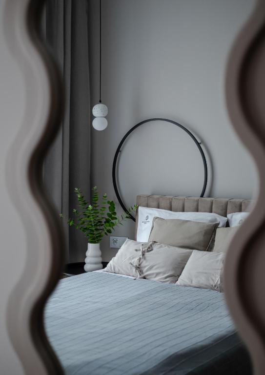 a bedroom with a large mirror and a bed at Baltic Sands Apartment- 15 min Beach Free Parking Premium Letnica in Gdańsk