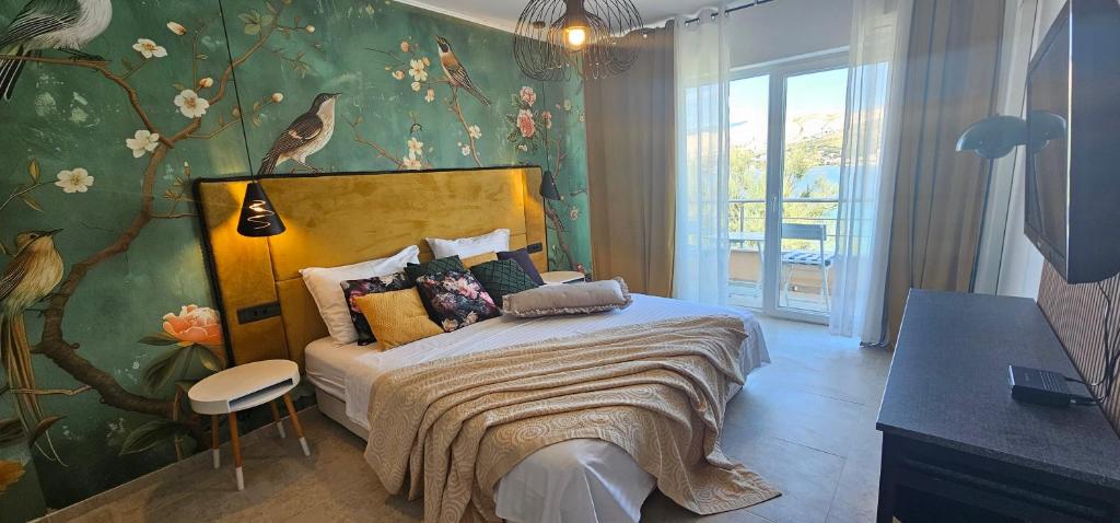 a bedroom with a bed with a floral wallpaper at Boutique Villa Revelin in Pag