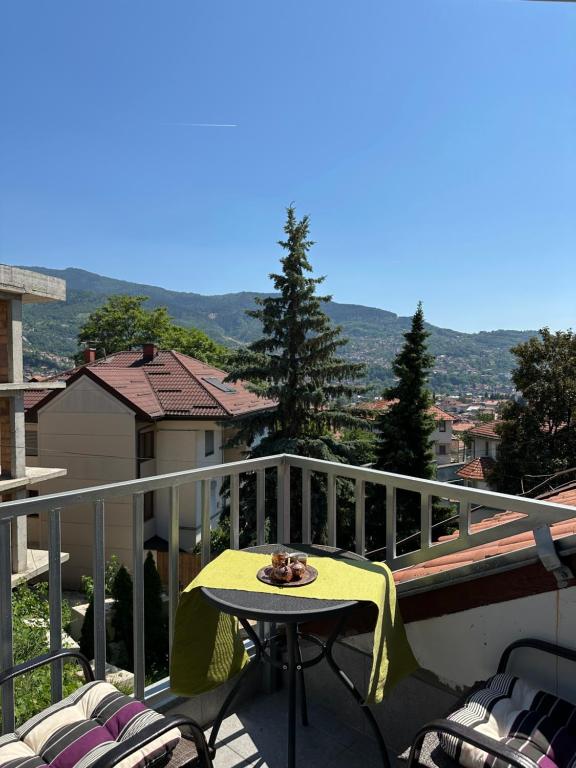 a table and chairs on a balcony with a view at One Love 2 in Sarajevo