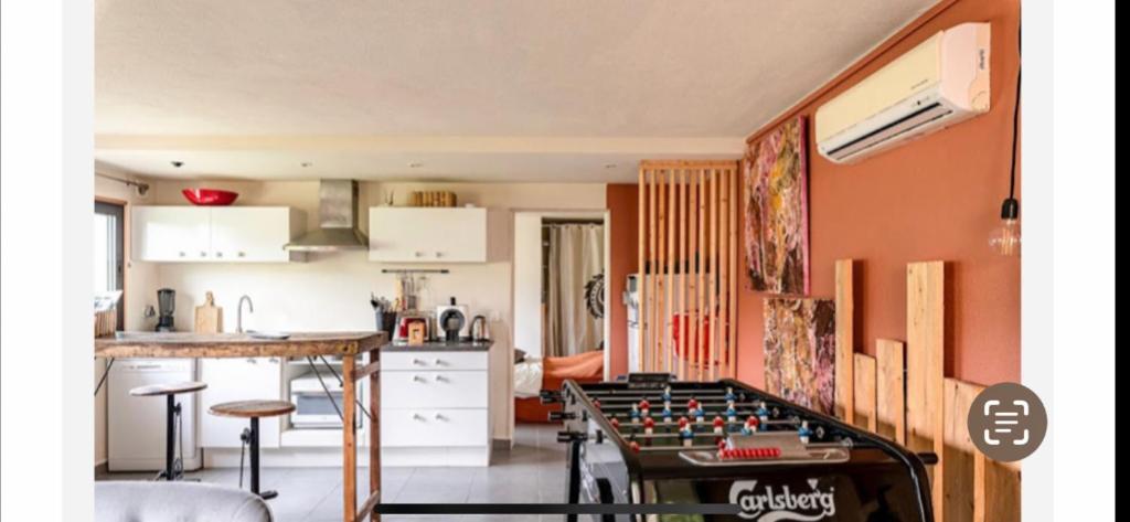 a kitchen with a foosball table in the middle of a room at T2 entre Mer et Montagnes in Porto-Vecchio