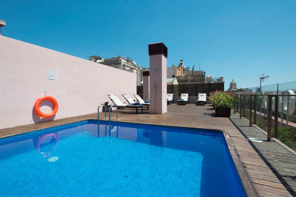 a swimming pool on the roof of a building at Onix Rambla in Barcelona