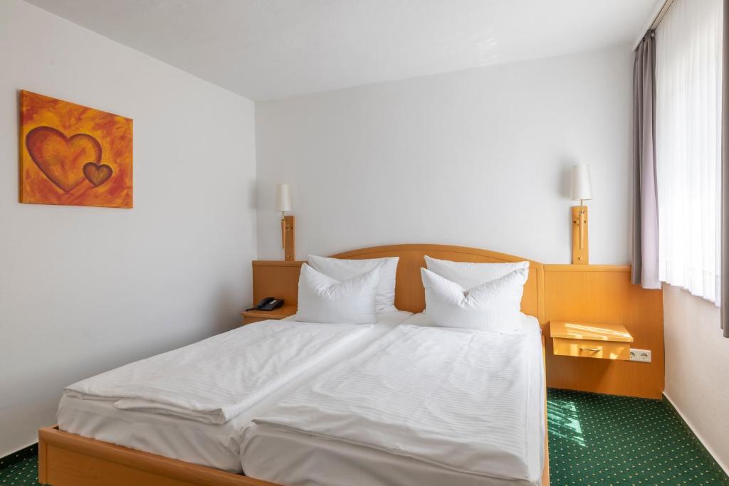 Postel nebo postele na pokoji v ubytování Hotel Schaper