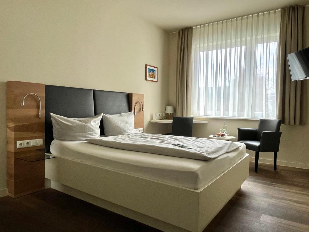 Voodi või voodid majutusasutuse Gasthaus Zur Noll toas