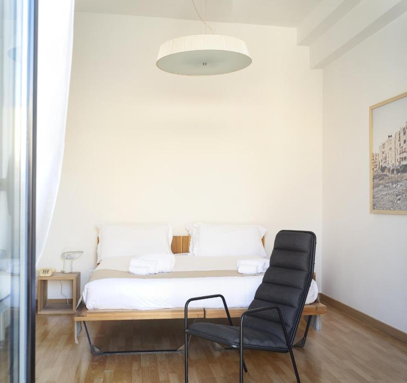 Llit o llits en una habitació de Imago Plus Hotel