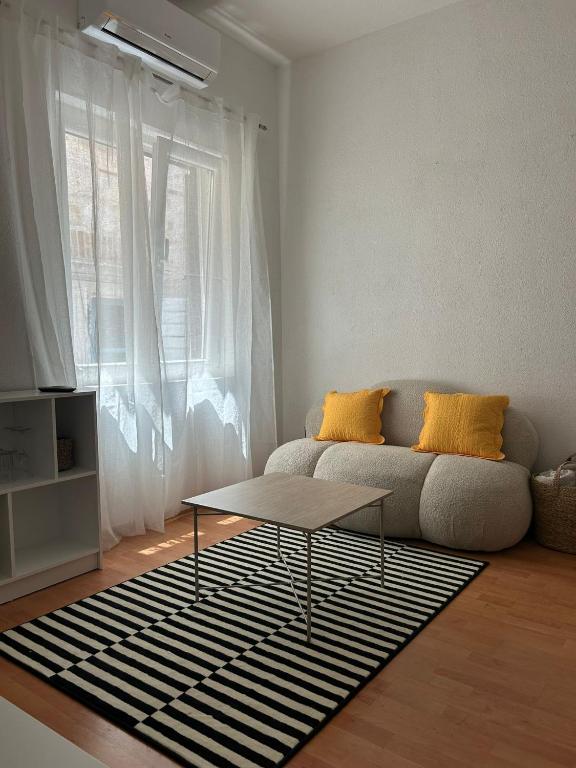 a living room with a couch and a table at Guest House Štorija, Vis Center, 1 min from Ferry in Vis