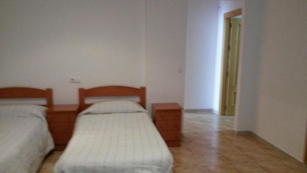 Posteľ alebo postele v izbe v ubytovaní Hostal Virgen Del Pilar