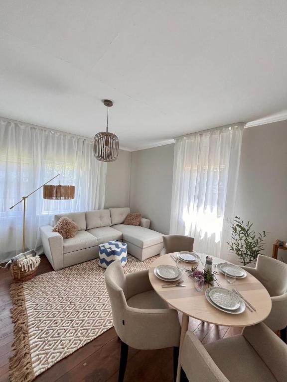 a living room with a table and a couch at Jūras Priedes in Ventspils