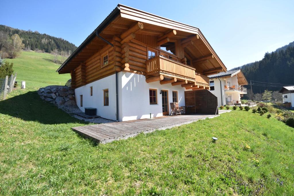 a house with a wooden roof on a hill at Ski-N-Lake Chalet One in Zell am See