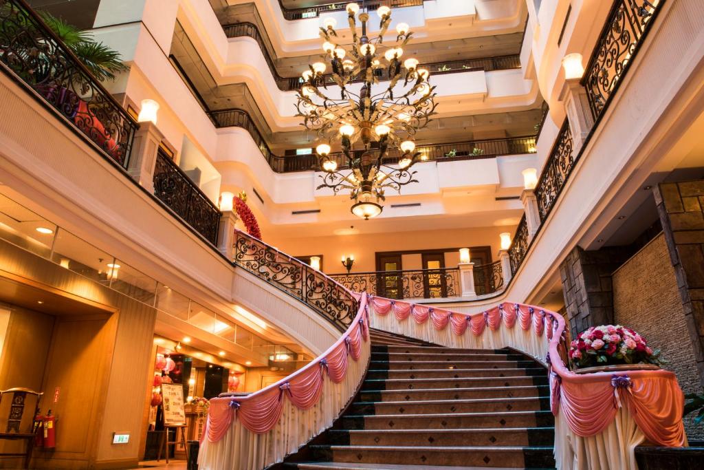 a set of stairs in a mall with a chandelier at Wei-Yat Grand Hotel in Anping