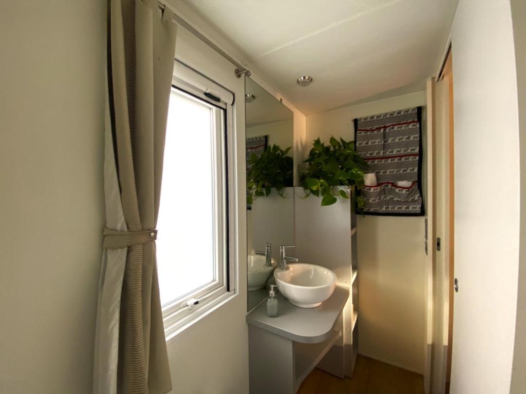 bagno con lavandino e finestra di Camping Torre di Barisardo a Bari Sardo