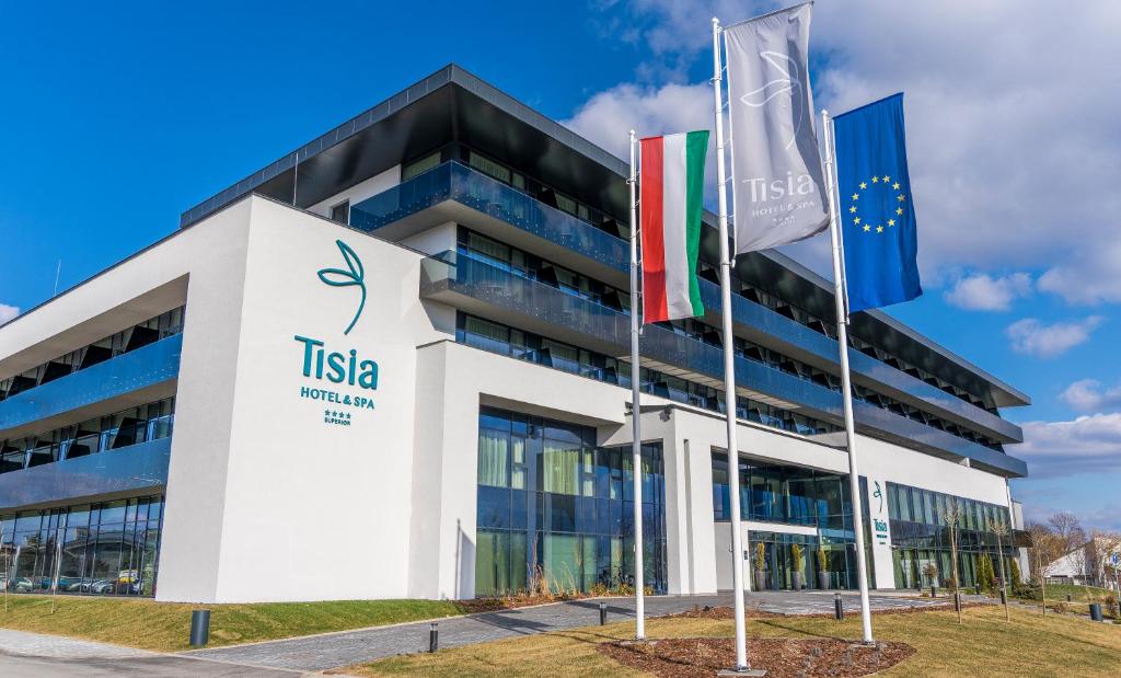 a building with flags in front of italia headquarters at Tisia Hotel & Spa in Tiszaújváros