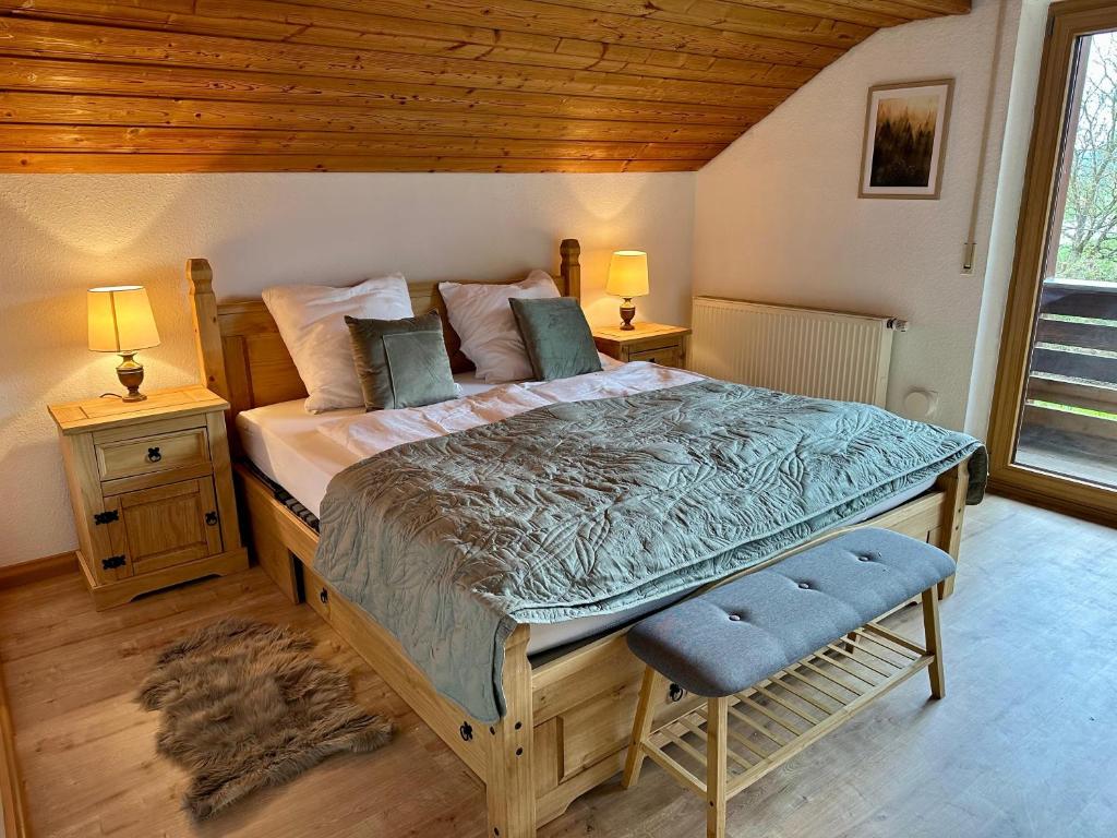a bedroom with a large bed with two night stands at Ferienwohnung am Staufen in Piding
