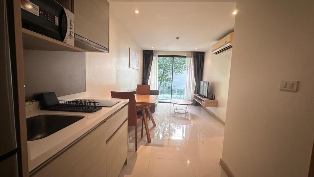 a kitchen with a sink and a counter top at Wonderful condo BTS Ekkamai 7min by walking in Bangkok