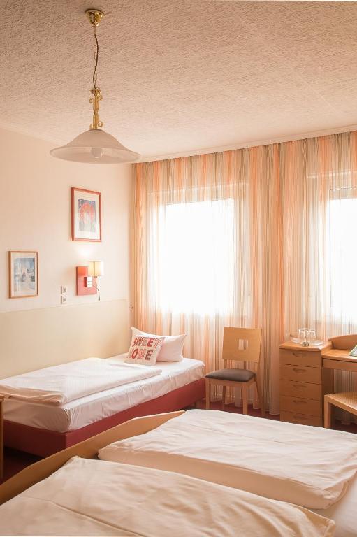 Postel nebo postele na pokoji v ubytování Hotel Leander