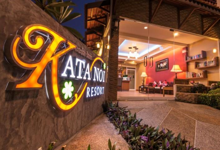 a sign for aaa notre resort on the side of a building at Katanoi Resort in Kata Beach