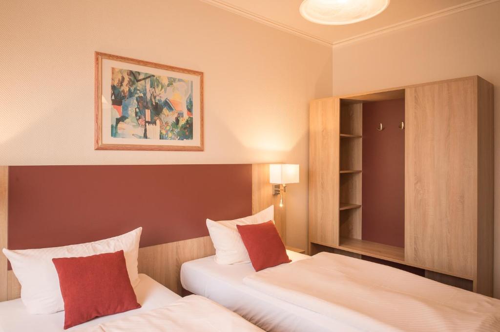 Postel nebo postele na pokoji v ubytování Hotel Leander