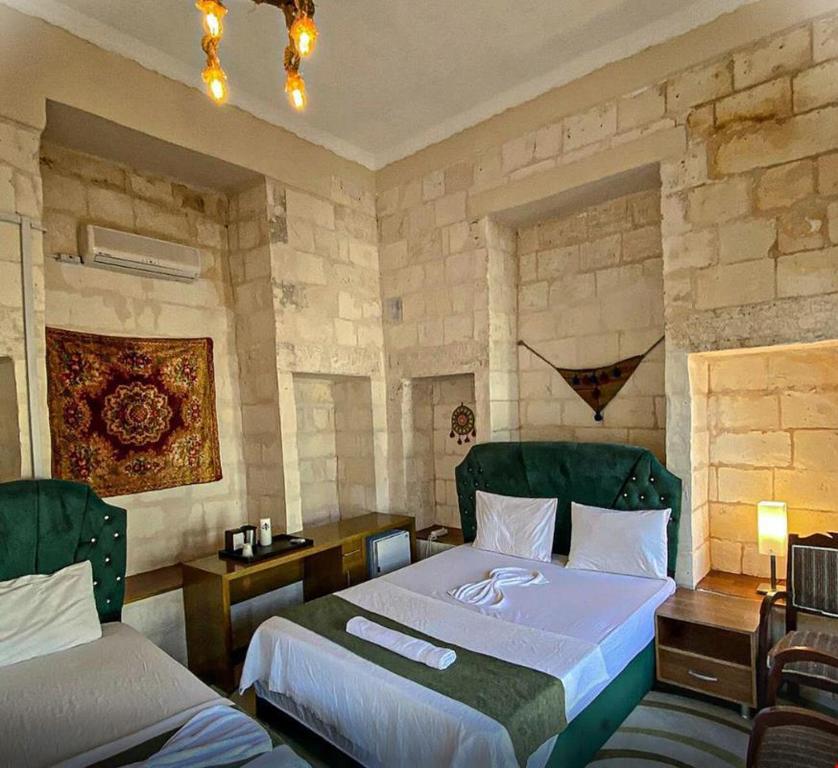 Postel nebo postele na pokoji v ubytování Hızmalı OTEL