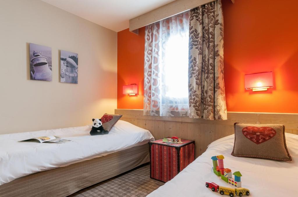 Postel nebo postele na pokoji v ubytování Résidence Pierre & Vacances Premium L'Amara