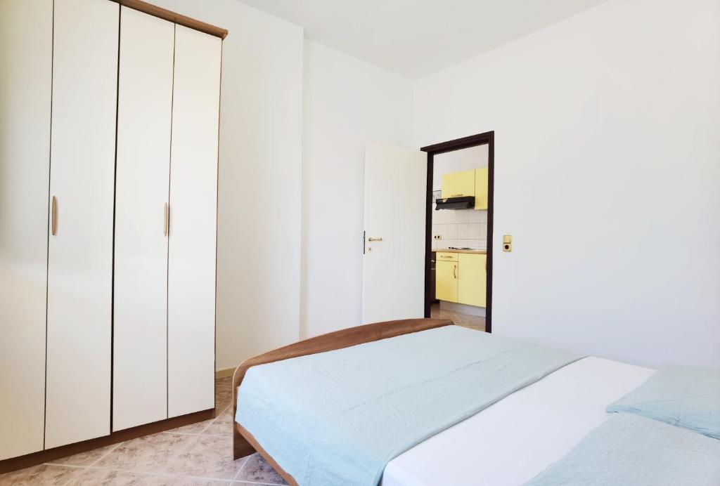 Postel nebo postele na pokoji v ubytování LiLu Apartments