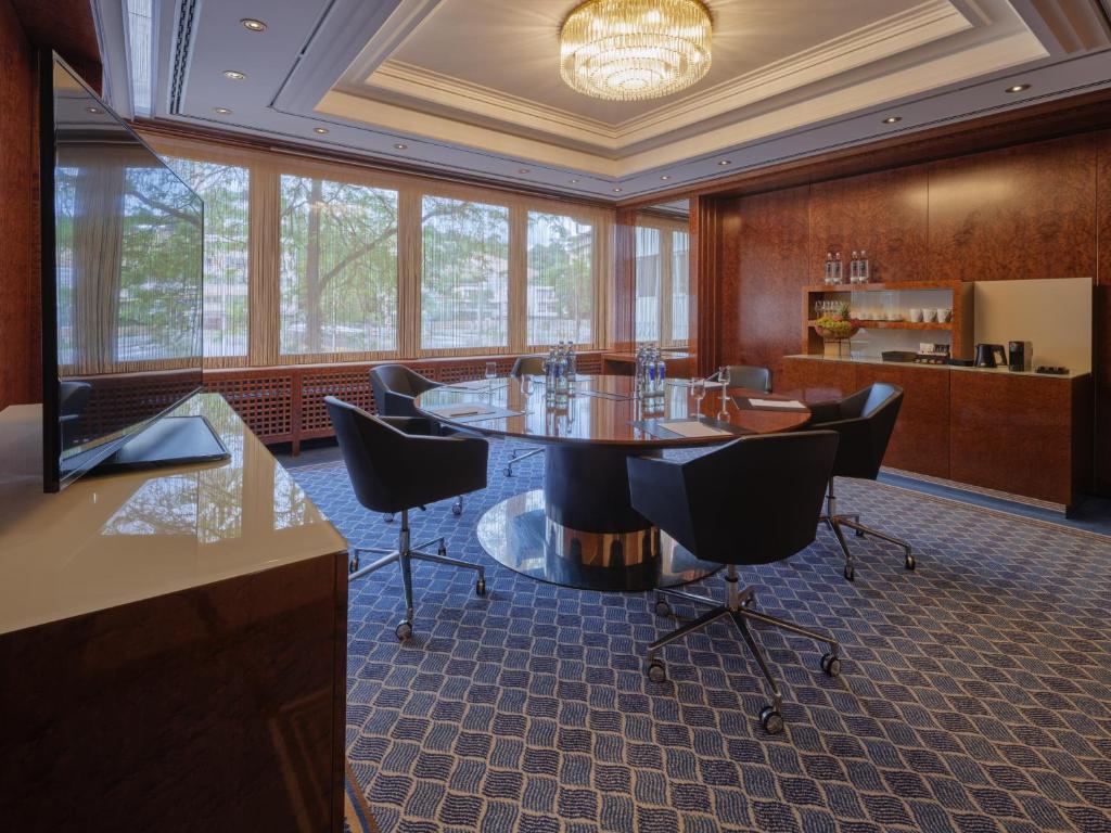 a conference room with a table and chairs at Steigenberger Graf Zeppelin in Stuttgart