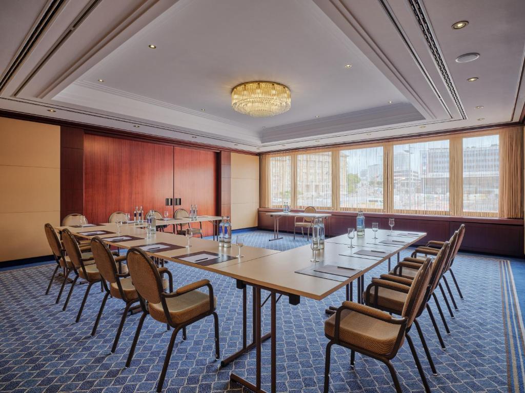 a conference room with a long table and chairs at Steigenberger Graf Zeppelin in Stuttgart