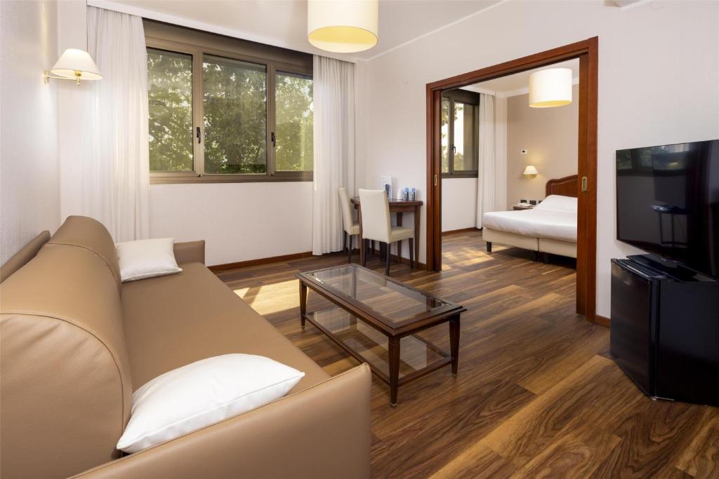 salon z kanapą i telewizorem w obiekcie Best Western Air Hotel Linate w mieście Segrate