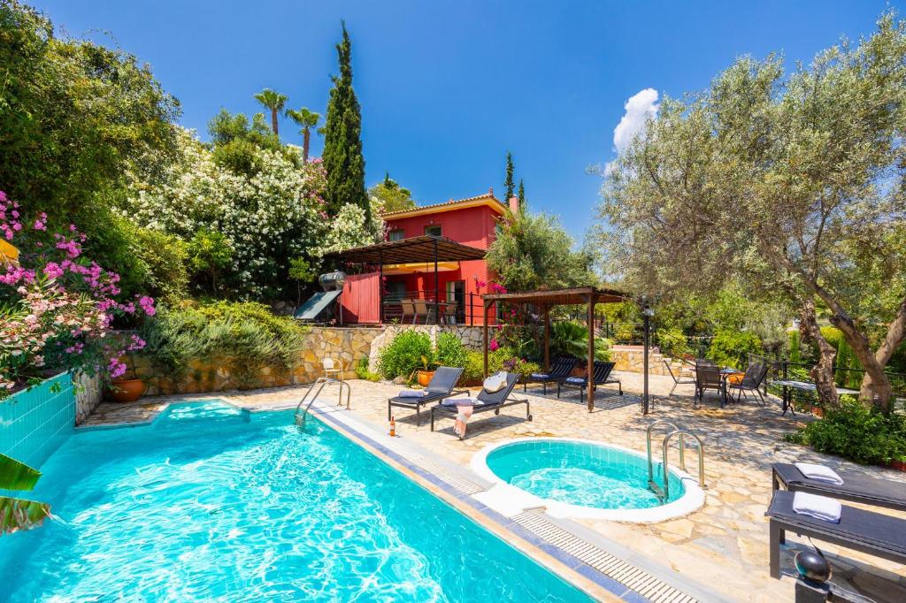 a house with a swimming pool in front of a house at Villa Poseidonia in Katelios