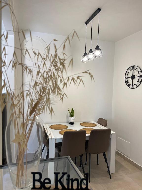 a dining room with a table with chairs and a clock at MagicFlo Santa Croce Appartamento in Florence