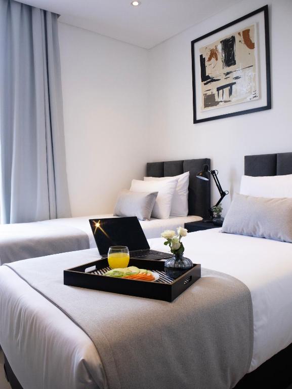 Postel nebo postele na pokoji v ubytování Divina Tower Apart Hotel