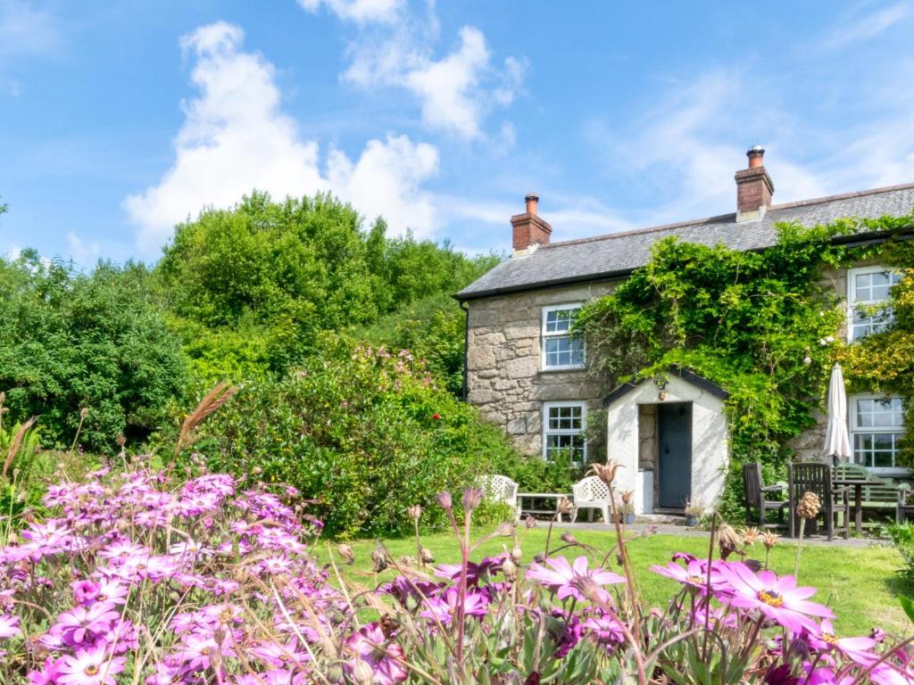 a stone house with flowers in front of it at 1 Bed in Portreath PENNA in Carnbrea