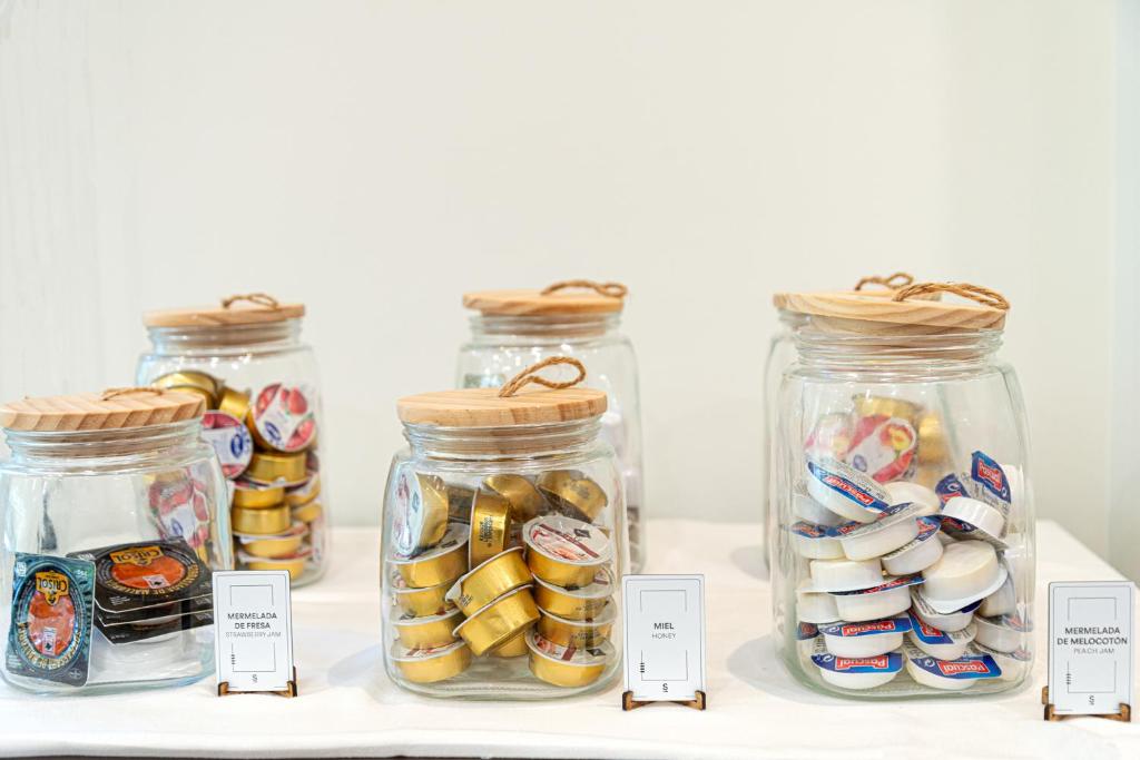 a group of jars filled with different types of food at Sercotel Riscal in Puerto Lumbreras
