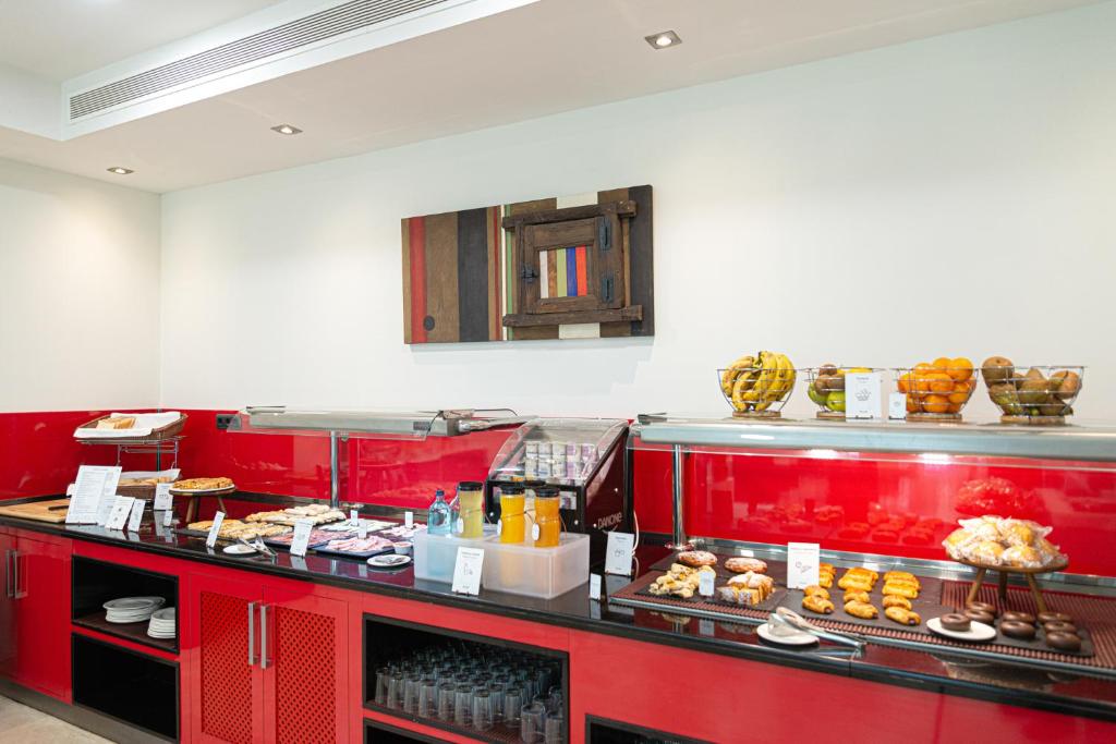 a buffet line with a bunch of pastries on it at Sercotel Riscal in Puerto Lumbreras