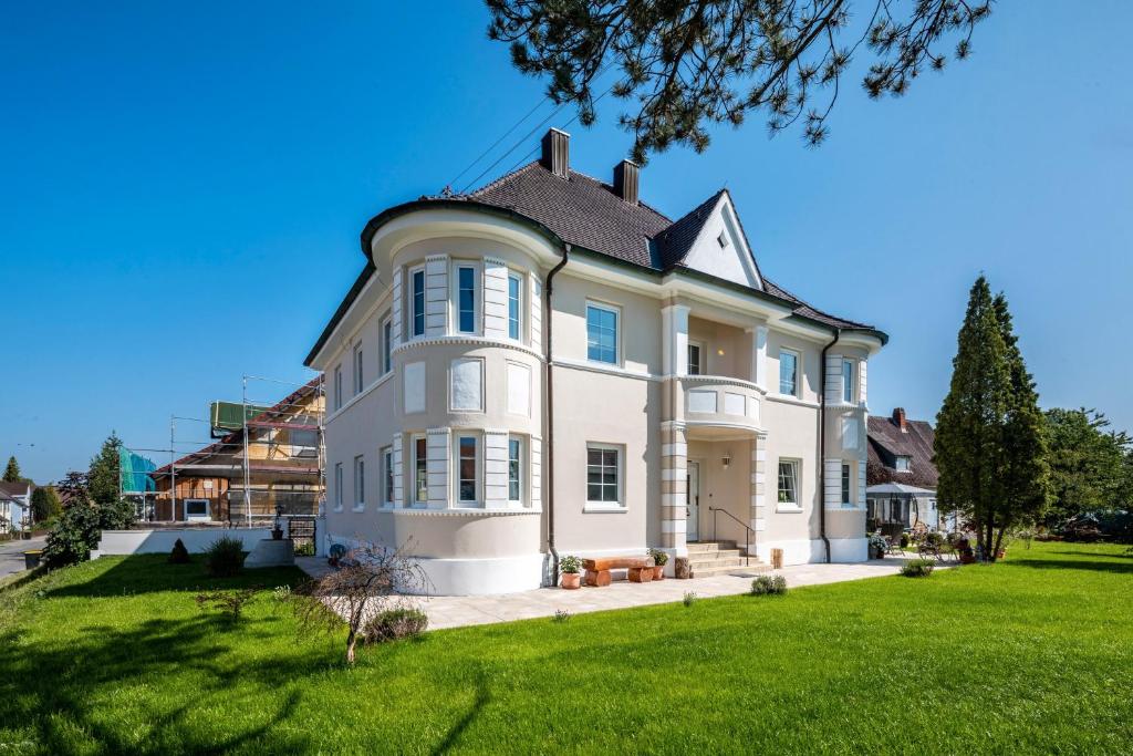a large white house with a roof at Villa Romantika in Ichenhausen