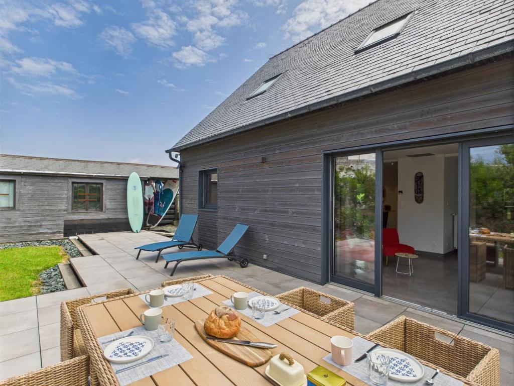 un patio avec une table et des chaises sur une terrasse dans l'établissement Charmante maison pour 5 au coeur de Penmarch, à Penmarcʼh