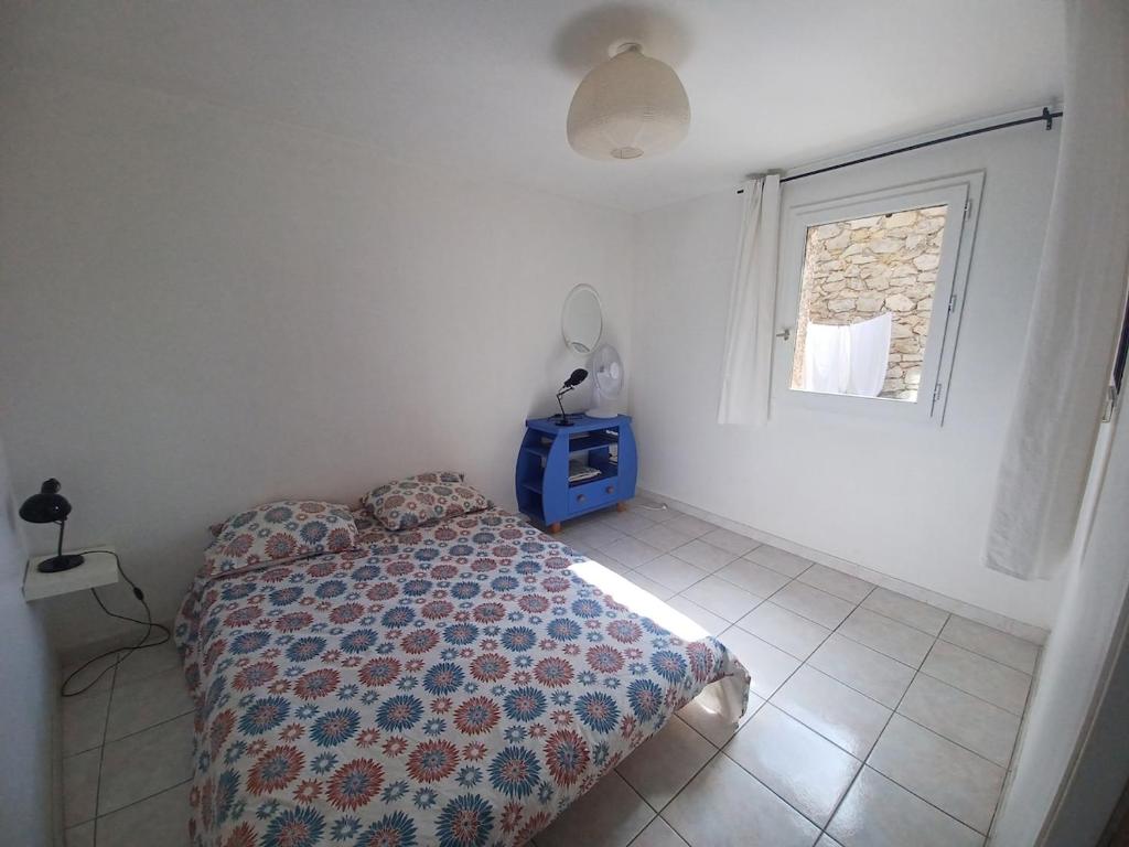 グリュイッサンにあるAu cœur du village de Gruissanのベッドと窓のある寝室