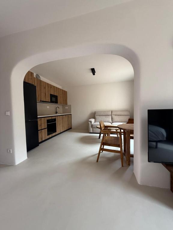 a white living room with a table and a couch at Casa Bel - Apartment 3 in Miami Platja