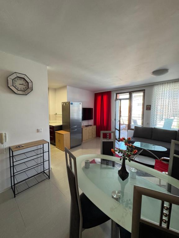 a kitchen and living room with a table and a couch at VP Palazzo Nesebar in Nesebar