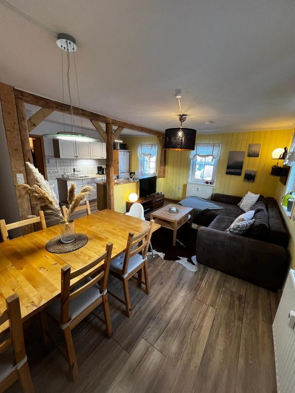 a living room with a table and a couch at Ferienwohnungen Carlsfeld in Eibenstock