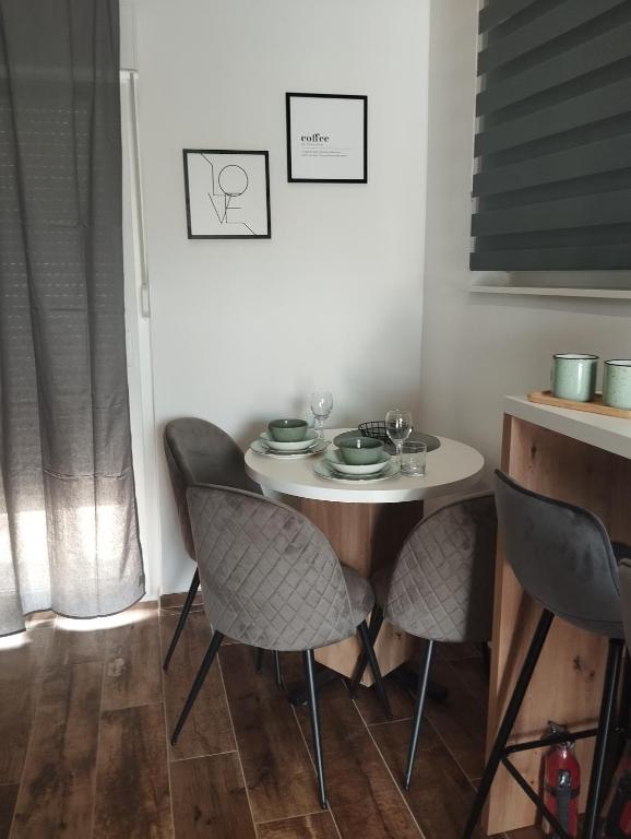 a small table and chairs in a room with a window at Amantis in Zadar