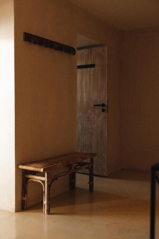 a wooden bench in a room with a door at Sea'Ya Thoughtful Stays - Villas in Cascais
