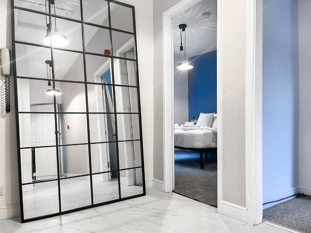 a mirror in a room with a bedroom at Pavilion Mews in Buxton