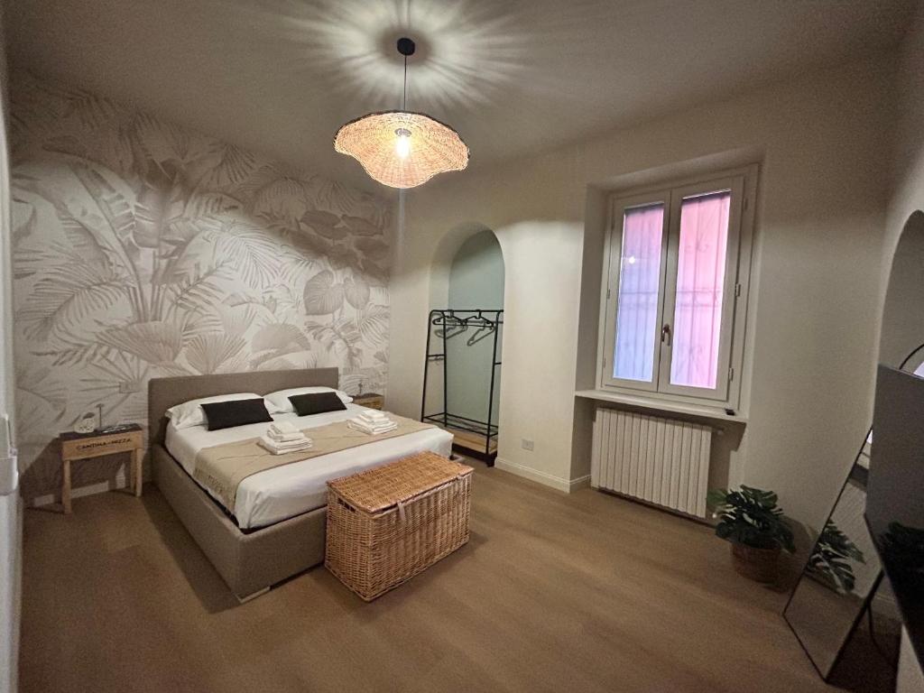 a bedroom with a bed and a chandelier at Casa Crova in Nizza Monferrato