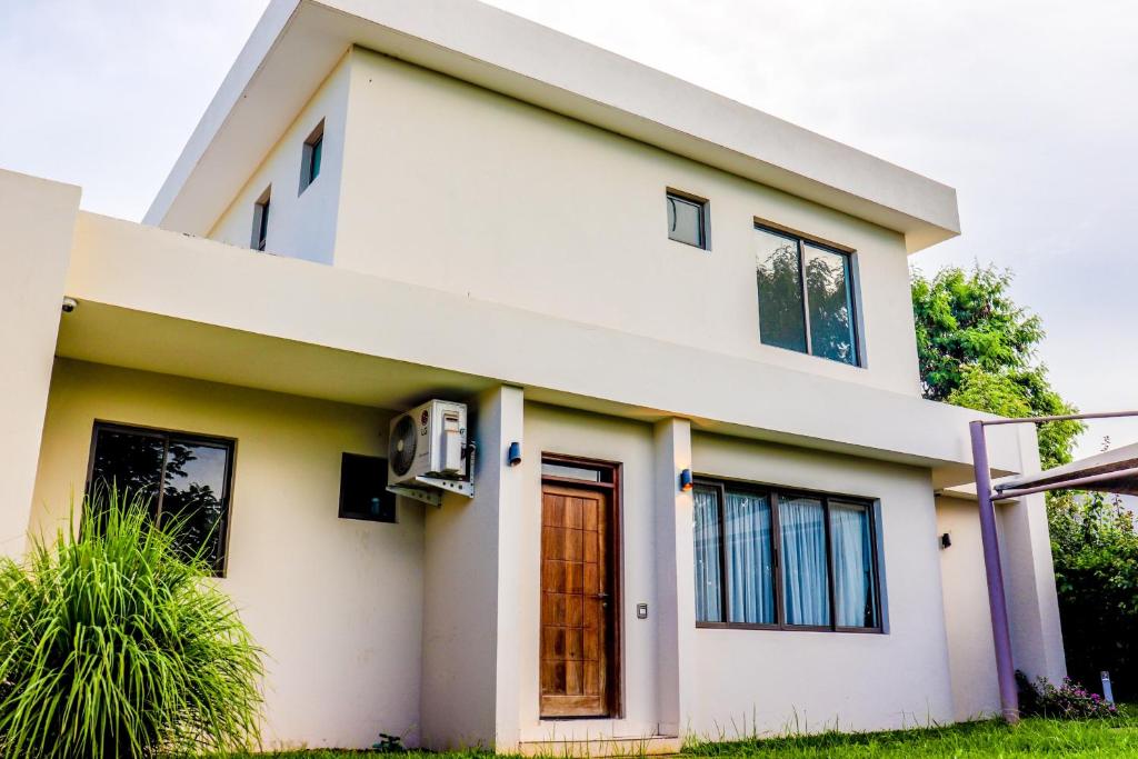 a white house with black windows at Lihanda Villa in Kilifi